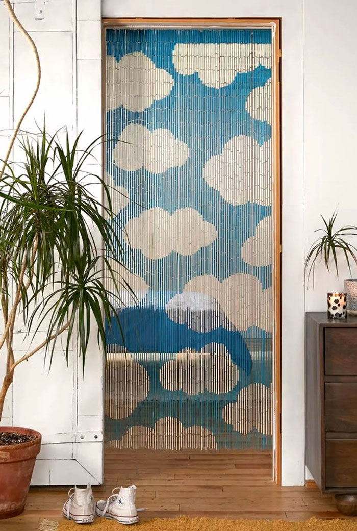 Beaded door curtain with cloud design in a stylish room showcasing cool interior design ideas and home decor.