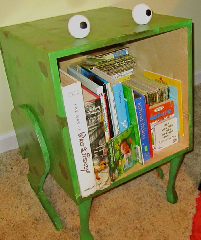 Green quirky bookshelf with googly eyes holding colorful books, showcasing cool interior design ideas for a fun home space.