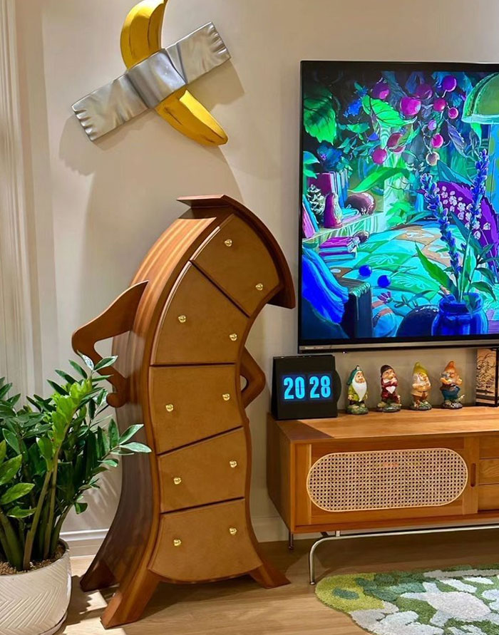 Unique cool interior design ideas featuring artistic curved wooden drawers, vibrant wall art, and eclectic home decor pieces.