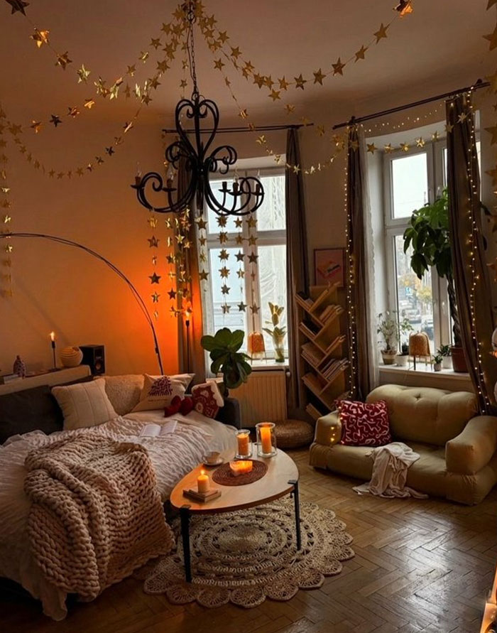 Cozy living room interior design with warm lighting, star decorations, plants, and comfortable seating for stylish home decor.