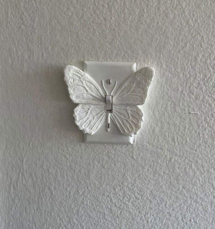Butterfly-shaped light switch cover in white, showcasing a cool interior design idea for enhancing home decor.