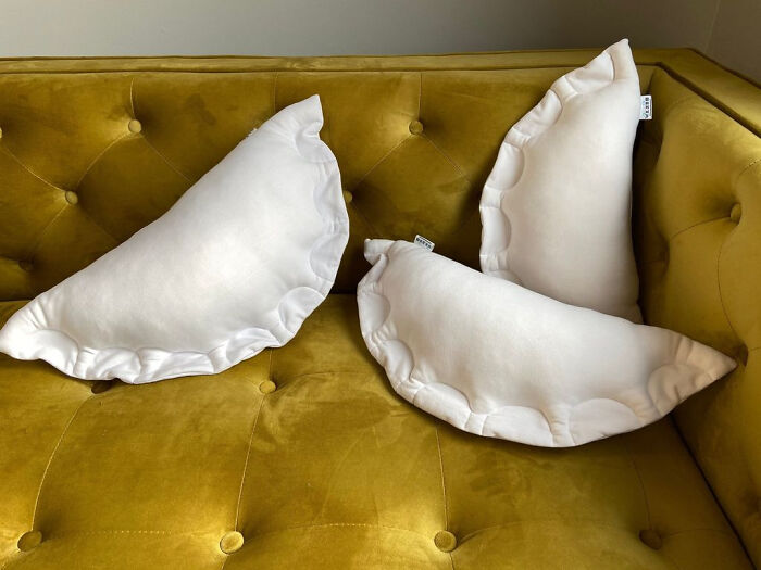 White ruffled pillows arranged on a mustard yellow tufted sofa showcasing cool interior design ideas.
