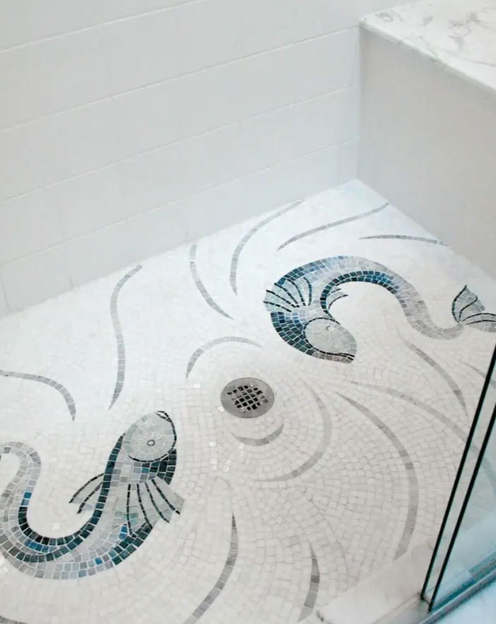 Shower floor mosaic with fish design, showcasing cool interior design ideas for transforming home spaces.