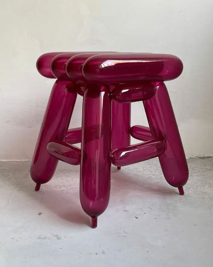 Glossy deep purple stool with a modern design, showcasing cool interior design ideas for transforming any home space.