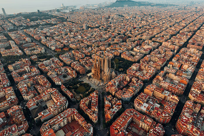 Aerial view of Barcelona grid with Sagrada Familia at center, dense cityscape, Tokyo