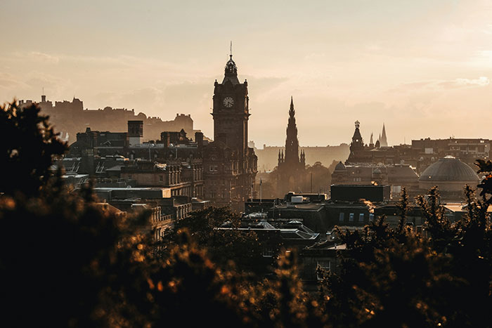 Sunset skyline with clock tower and spires, a scene for Tokyo and other coolest cities travel inspiration