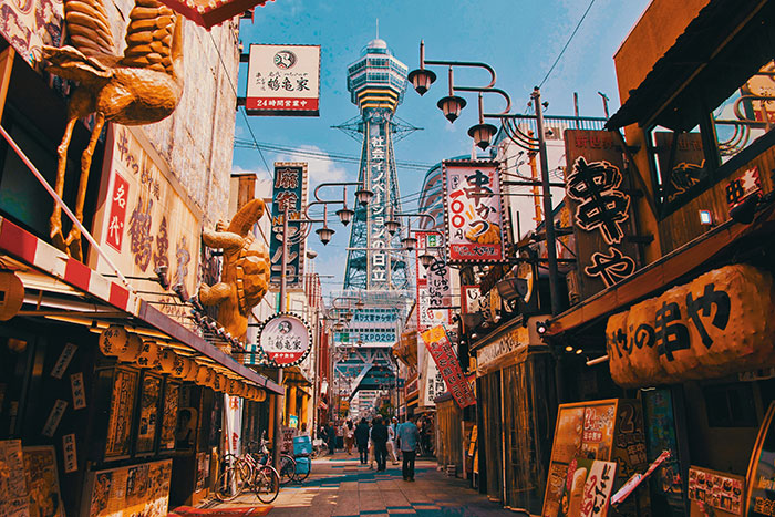 Colorful Japanese shopping street with lanterns, signs and pedestrians, Tokyo travel scene