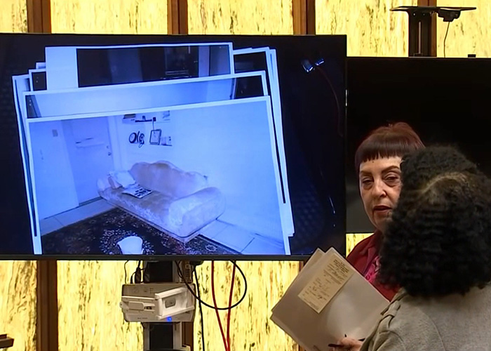 Two women discussing evidence files in front of a screen showing a room scene related to Alligator Alley disappearance case. Two women discussing evidence files in front of a screen showing a room scene related to Alligator Alley disappearance case.