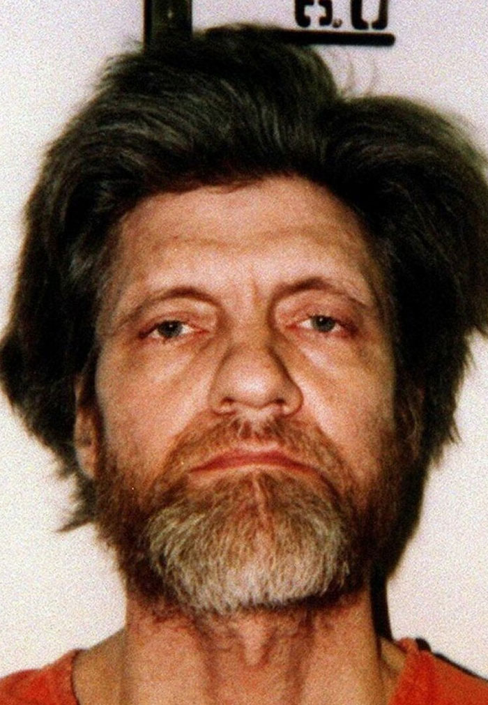 Mugshot of man with intense stare and unkempt hair, illustrating sharp intelligence that made brain feel like spaghetti.