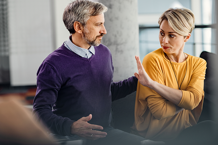 Middle-aged man and woman having tense conversation indoors, illustrating dad’s mistress texts and family conflict on NYE. Middle-aged man and woman having tense conversation indoors, illustrating dad’s mistress texts and family conflict on NYE.
