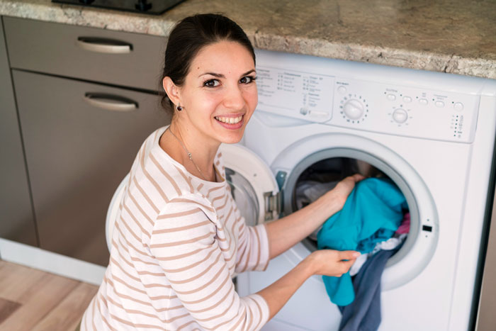 Woman doing laundry at home, illustrating chores related to annoyed mom and teen daughter conflict themes. Woman doing laundry at home, illustrating chores related to annoyed mom and teen daughter conflict themes.