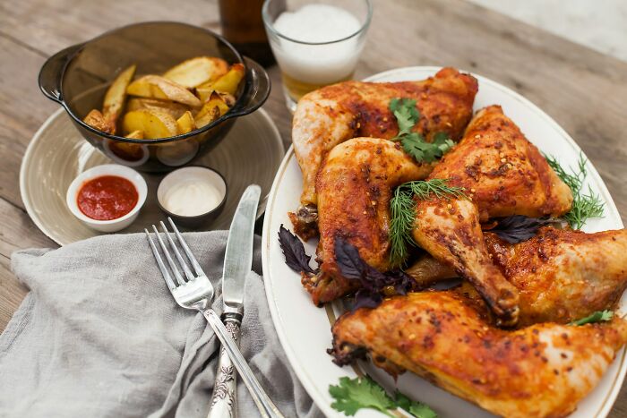 Grilled chicken and potato wedges served with sauces illustrating daily dangers you might not realize exposure to.