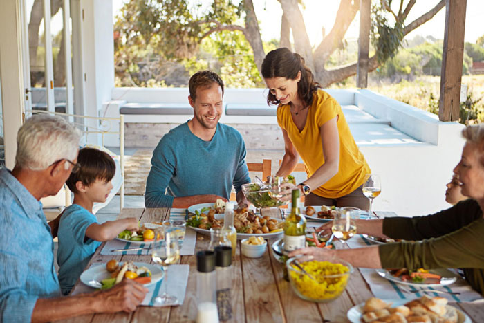 Family enjoying outdoor meal together, highlighting tension as man calls daughter-in-law fat while others react. Family enjoying outdoor meal together, highlighting tension as man calls daughter-in-law fat while others react.