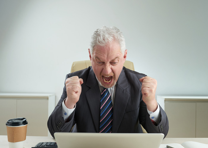 Angry American boss in suit yelling at laptop, reacting to Dutch worker logging off at 5PM and giving a reality check. Angry American boss in suit yelling at laptop, reacting to Dutch worker logging off at 5PM and giving a reality check.