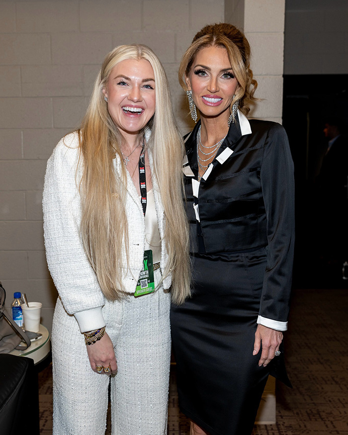 Two women smiling indoors, highlighting Erika Kirk's makeup transformation before Charlie's assassination.