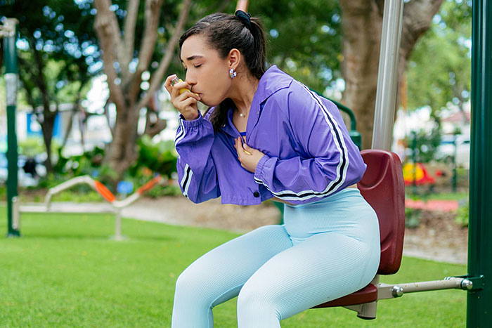 Woman in purple jacket and leggings at outdoor gym, capturing moment realizing expert was wrong in unexpected way