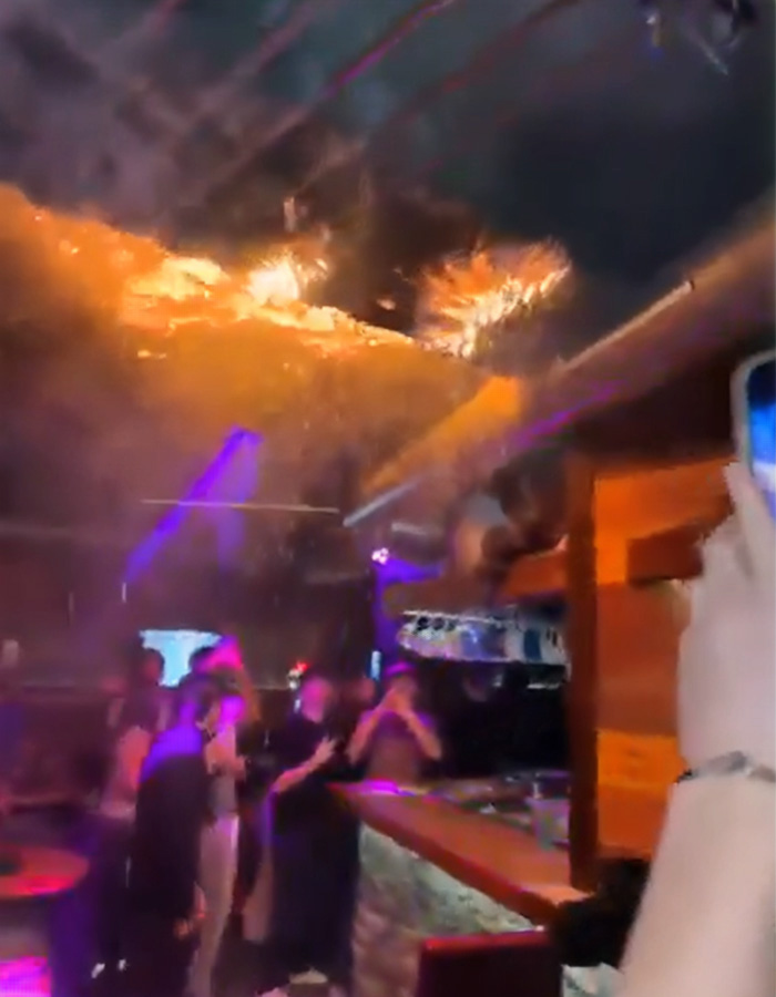 People inside a ski resort bar with towering flames on the ceiling during the fire that claimed 40 lives in Switzerland.