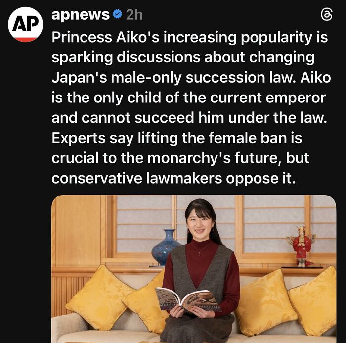 Princess Aiko reading a book on a couch, highlighting feminist discussions on patriarchy and succession law debates.