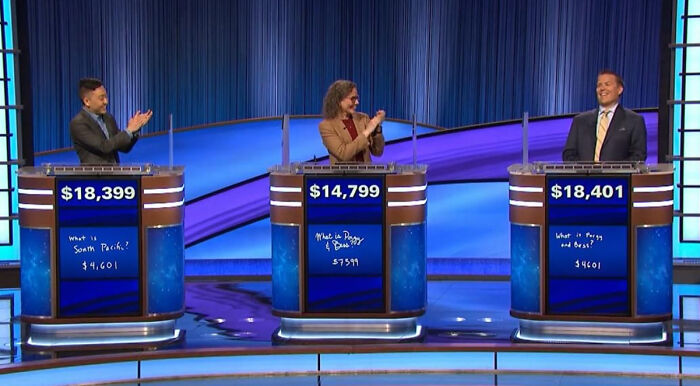 Three Jeopardy contestants at podiums applauding on blue set, creepiest displays of intelligence