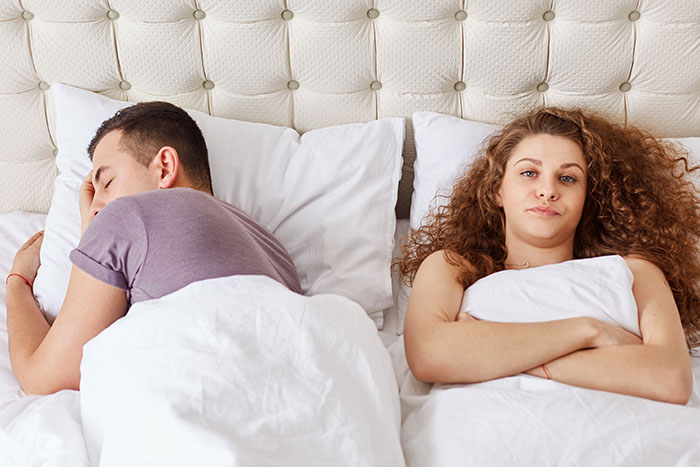 Man breaks off engagement: upset girlfriend lies awake while partner sleeps with back turned in bed