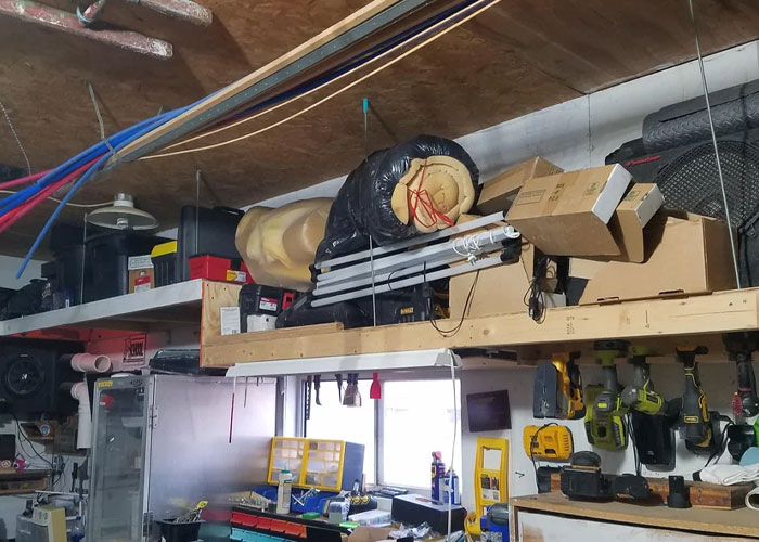 Cluttered garage with home improvement tools and materials highlighting common homeownership nightmares and challenges.