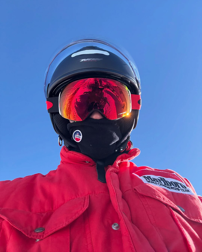 Pierre Gasly wearing racing gear and a helmet, pictured outdoors under clear blue sky amid F1 tribute controversy.