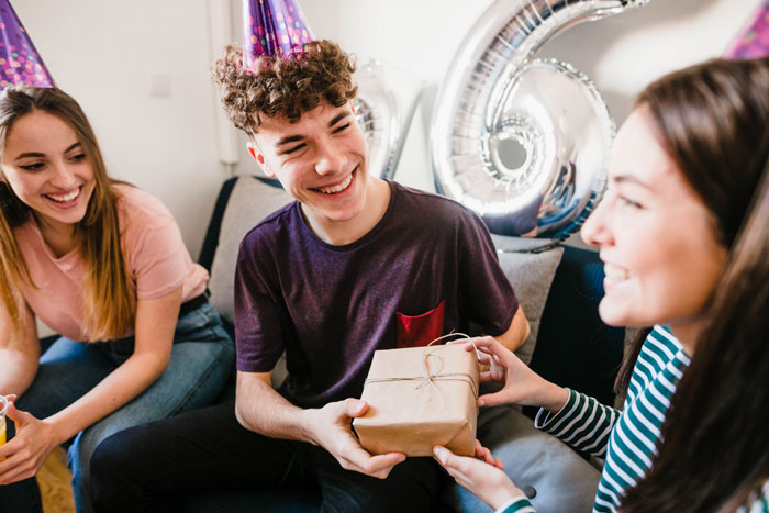 Young people at a birthday party with balloons, highlighting birthday host and bestie&rsquo;s boyfriend drama and party vibe conflict.