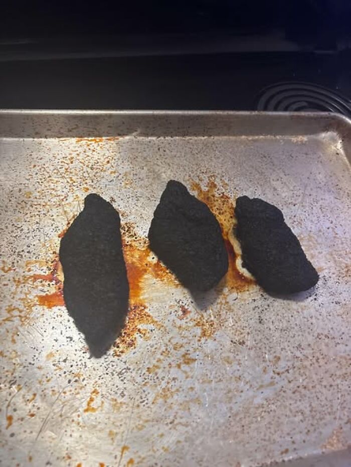 Three charred chicken pieces on a scorched baking sheet, woke up expecting a normal day