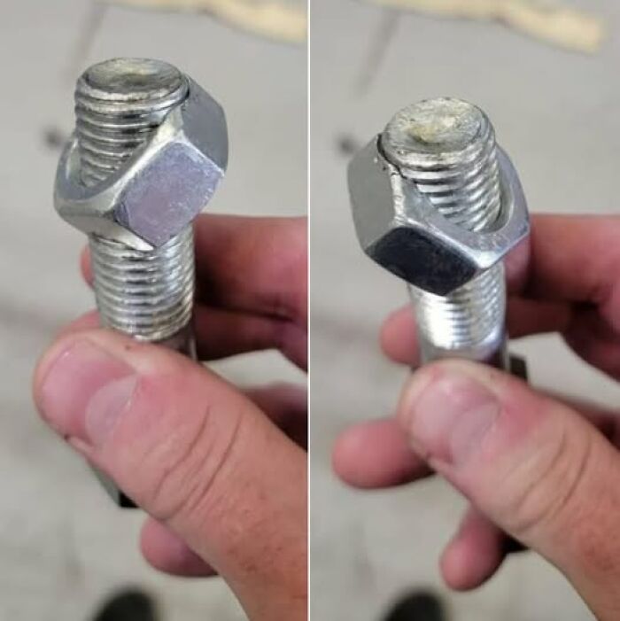 Hand holding a jammed bolt and cross-threaded nut, DIY fail - woke up expecting normal day