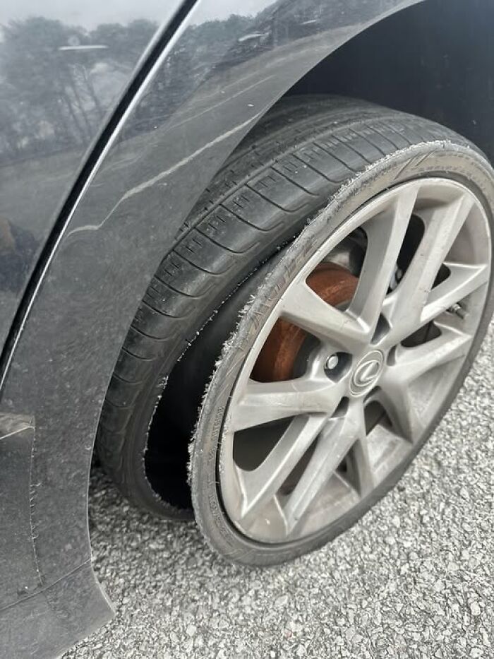Woke up expecting a normal day: shredded car tire and bent rim on a parked Lexus wheel