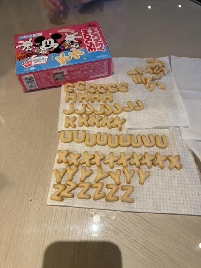 Woke up to alphabet crackers arranged by letter on napkins with a Mickey Mouse snack box nearby.