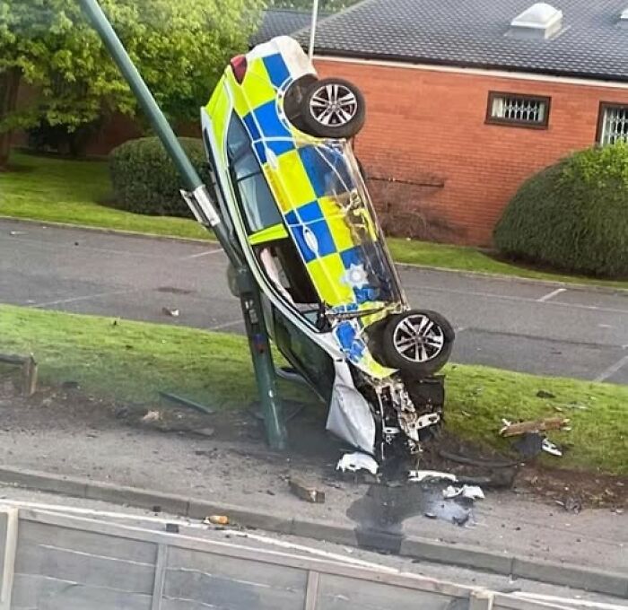 Police car crashed vertically into lamppost on grass verge, wheels up — woke up expecting a normal day