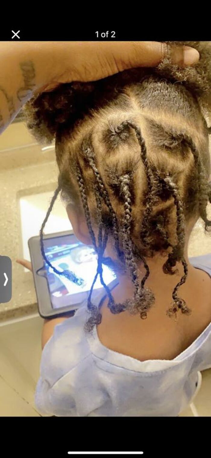 Child with a series of uneven and messy braids viewed from the back, showcasing one of the disastrous hairstyles.