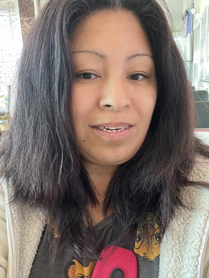 Woman with messy, uneven hair showcasing one of the disastrous hairstyles that may raise questions about life decisions.