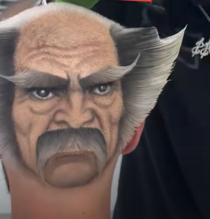 Unique disastrous hairstyle featuring a detailed face painting on the back of a person’s head and hair styled upwards.