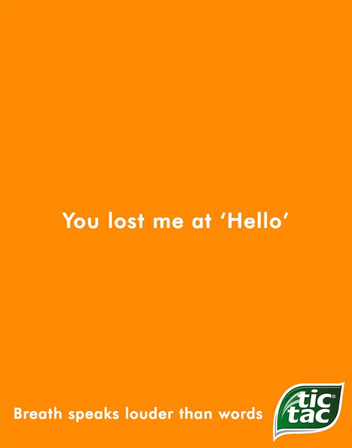 Print advertisement using humor and creativity from Tic Tac with a bold orange background and catchy slogan.