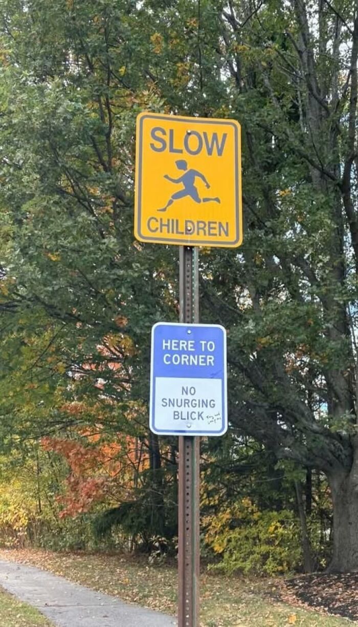 Yellow slow children road sign with a person running, paired with a confusing blue sign, illustrating people breaking their brain reading.
