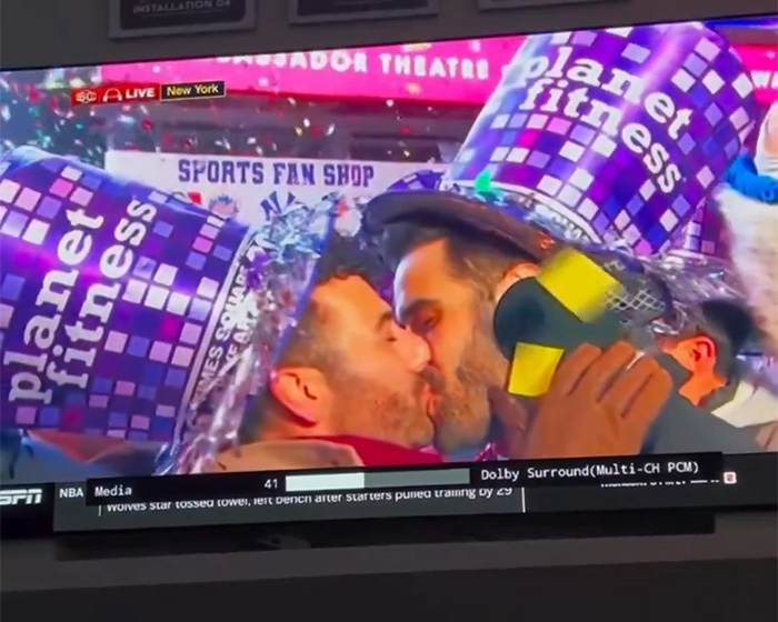 Gay couple kissing on live TV New Year's Eve, wearing Planet Fitness party hats during an ESPN broadcast Gay couple kissing on live TV New Year's Eve, wearing Planet Fitness party hats during an ESPN broadcast