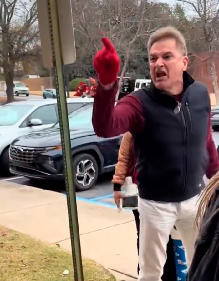 Man known as male version of Karen gestures angrily during public meltdown in a parking lot with cars in the background. Man known as male version of Karen gestures angrily during public meltdown in a parking lot with cars in the background.