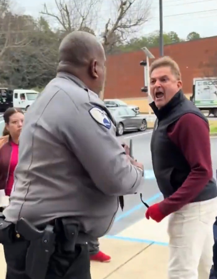Man known as male version of Karen shouting at police officer during public meltdown on city sidewalk.
