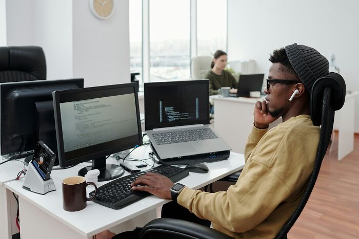 Young man working at a computer in an office, reflecting on moments people realized they no longer wanted to work.