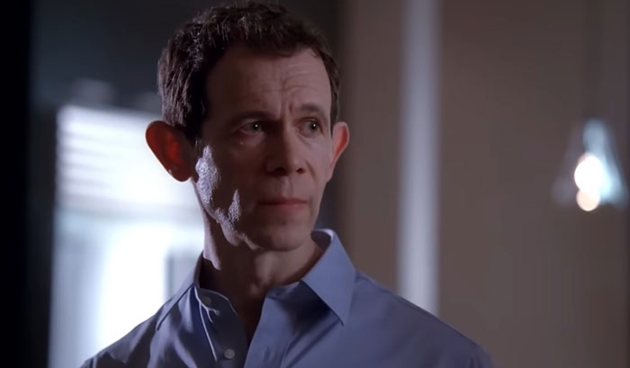 Man in blue shirt looking serious indoors, related to woman demands swimmer boyfriend story discussion. Man in blue shirt looking serious indoors, related to woman demands swimmer boyfriend story discussion.