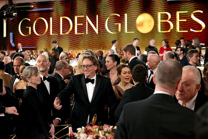 Guests mingle at the 2026 Golden Globes amid chaos as arrogant stars leave early and smoke despite the ban at tables.