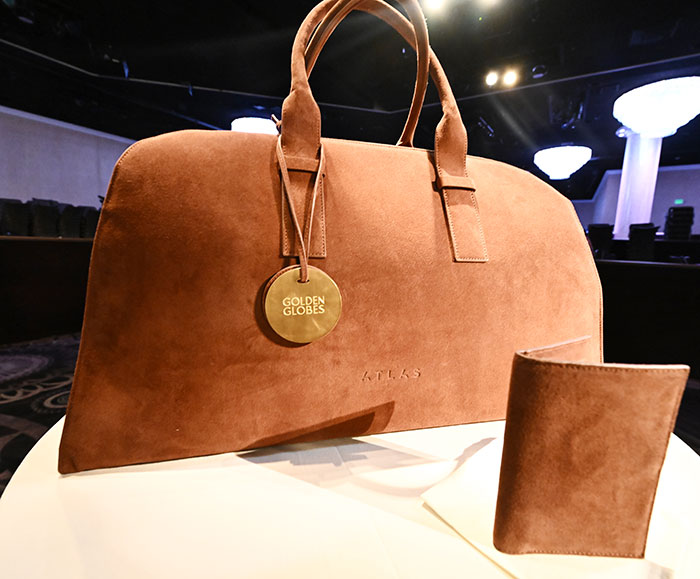 Brown leather bag and wallet showcased on a table, highlighting strict rules celebrities follow during award shows.