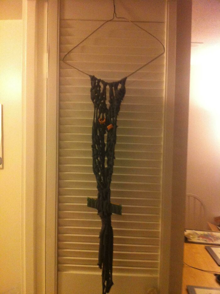 Failed DIY project hanging unevenly on a door, showcasing a poorly executed homemade craft in a home interior.