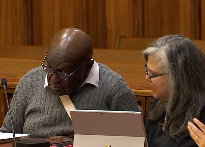 Two people in a courtroom setting reviewing documents related to a five-year-old’s chilling last words case. Two people in a courtroom setting reviewing documents related to a five-year-old’s chilling last words case.