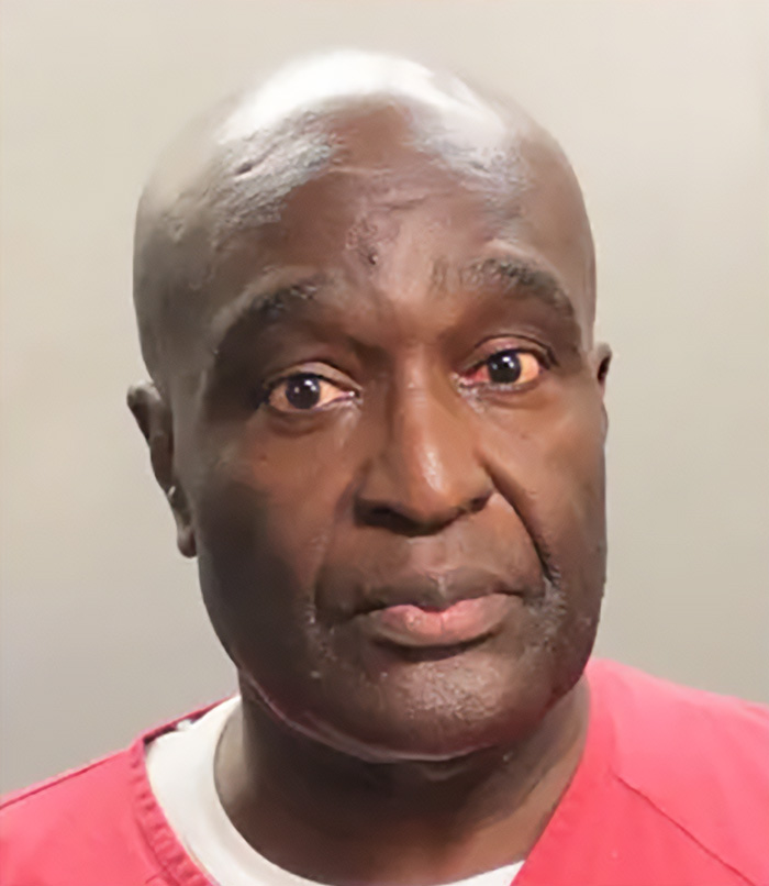Close-up of a man in red prison clothing with a serious expression related to five-year-old’s chilling last words disappearance case in Alligator Alley. Close-up of a man in red prison clothing with a serious expression related to five-year-old’s chilling last words disappearance case in Alligator Alley.