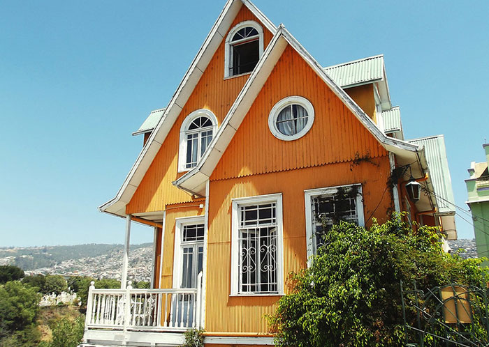 Orange house with white trim under clear sky, symbolizing HOA president power-trip harassment incident in a residential neighborhood.