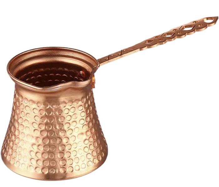 Copper cezve pot with long handle used for making traditional coffee, a unique household item from specific countries.