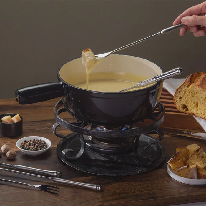 Fondue pot with melted cheese, bread cubes, and spices, illustrating unique household items from different countries.